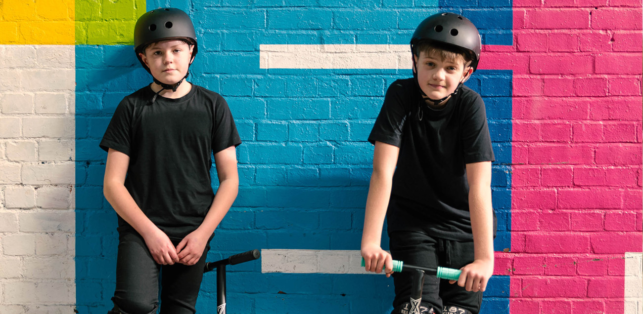 2 boys wearing bike helmets
