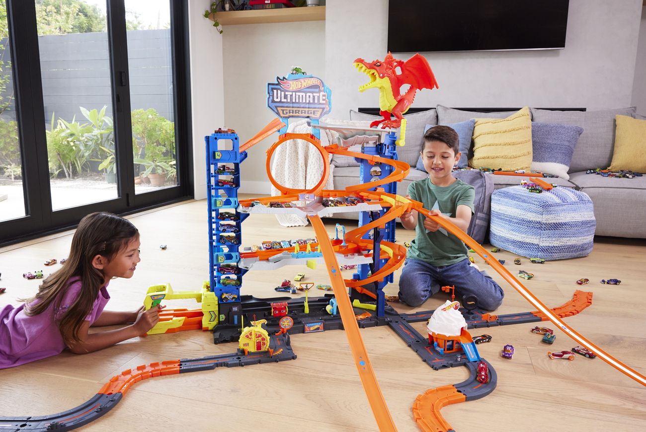 Kids playing with Hot Wheels tracks.