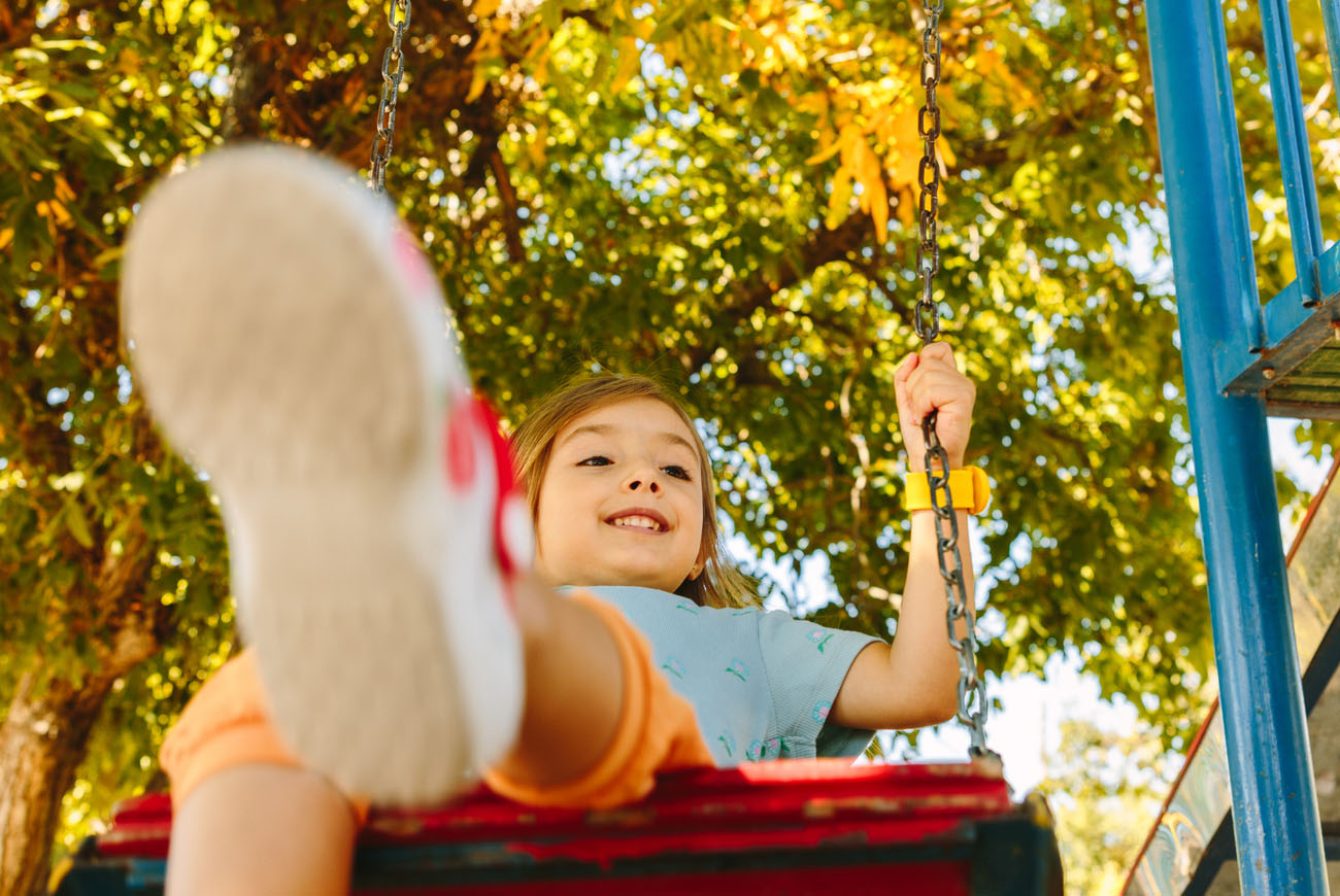 Child on swing set.