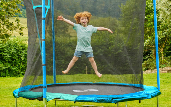 Boy jumping on a large trampoline