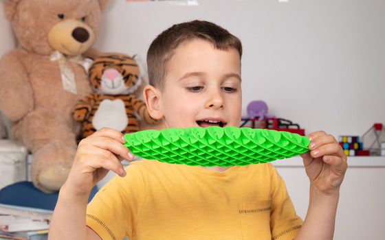Boy playing with e Flexiworm fidget toy