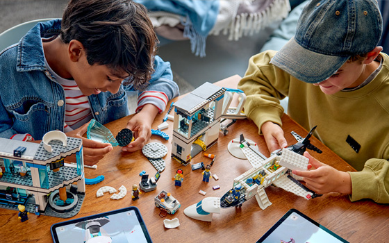 Boys building a LEGO City airplane set