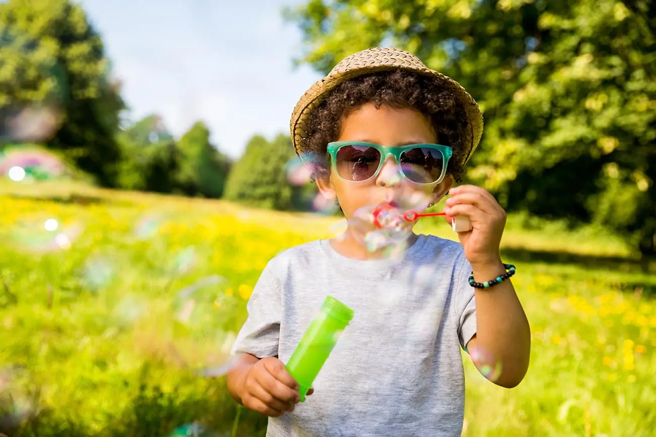 child blowing bubbles