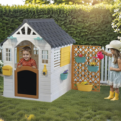 Children playing in the Dolu white and yellow playhouse with electronic doorbell