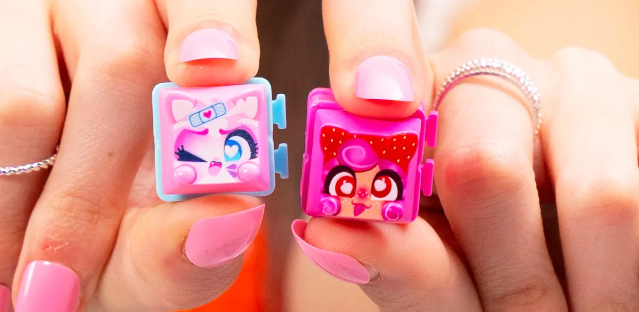 Close up of a girl holding up fidget toys Clickeez