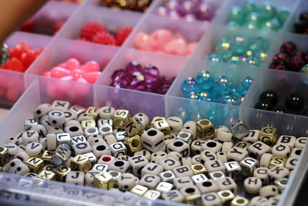 Collection of alphabet and other beads and jewellery making supplies