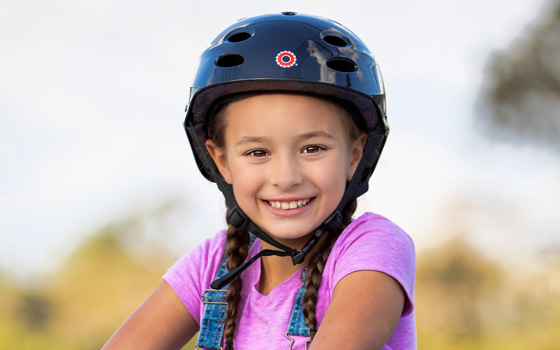 Girl smiling wearing a bike helmet