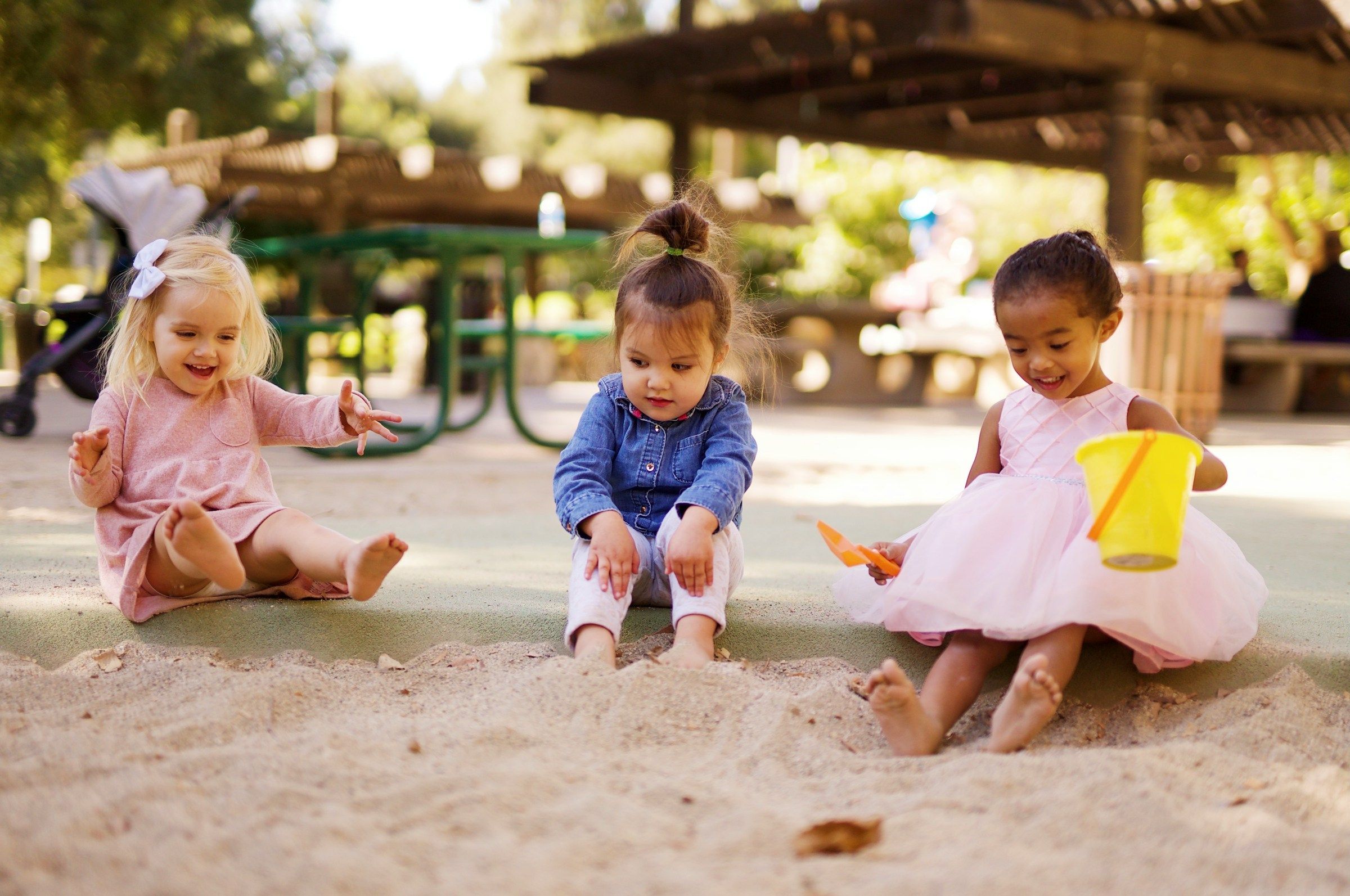 Little girls playing in sand.