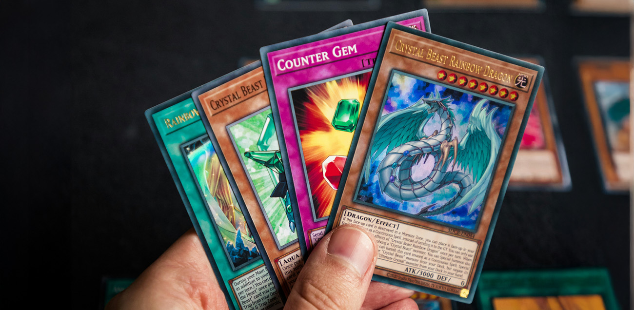 Hand holding a set of Yu-Gi-Oh trading cards