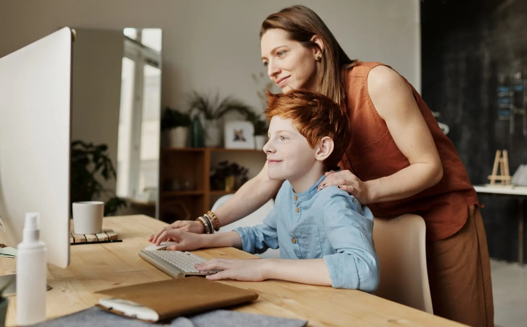 Mum studying with child.