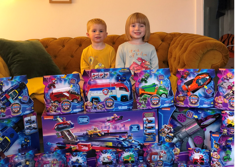 Boy and girl with paw patrol toys.