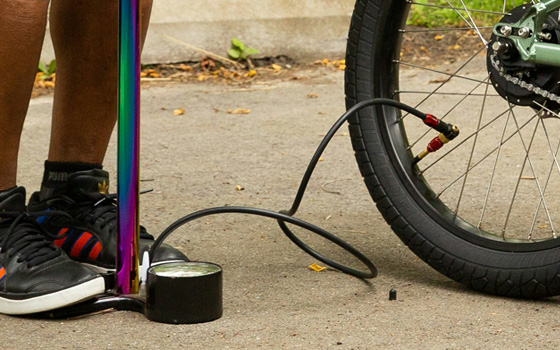 Pumping up a flat bike tyre