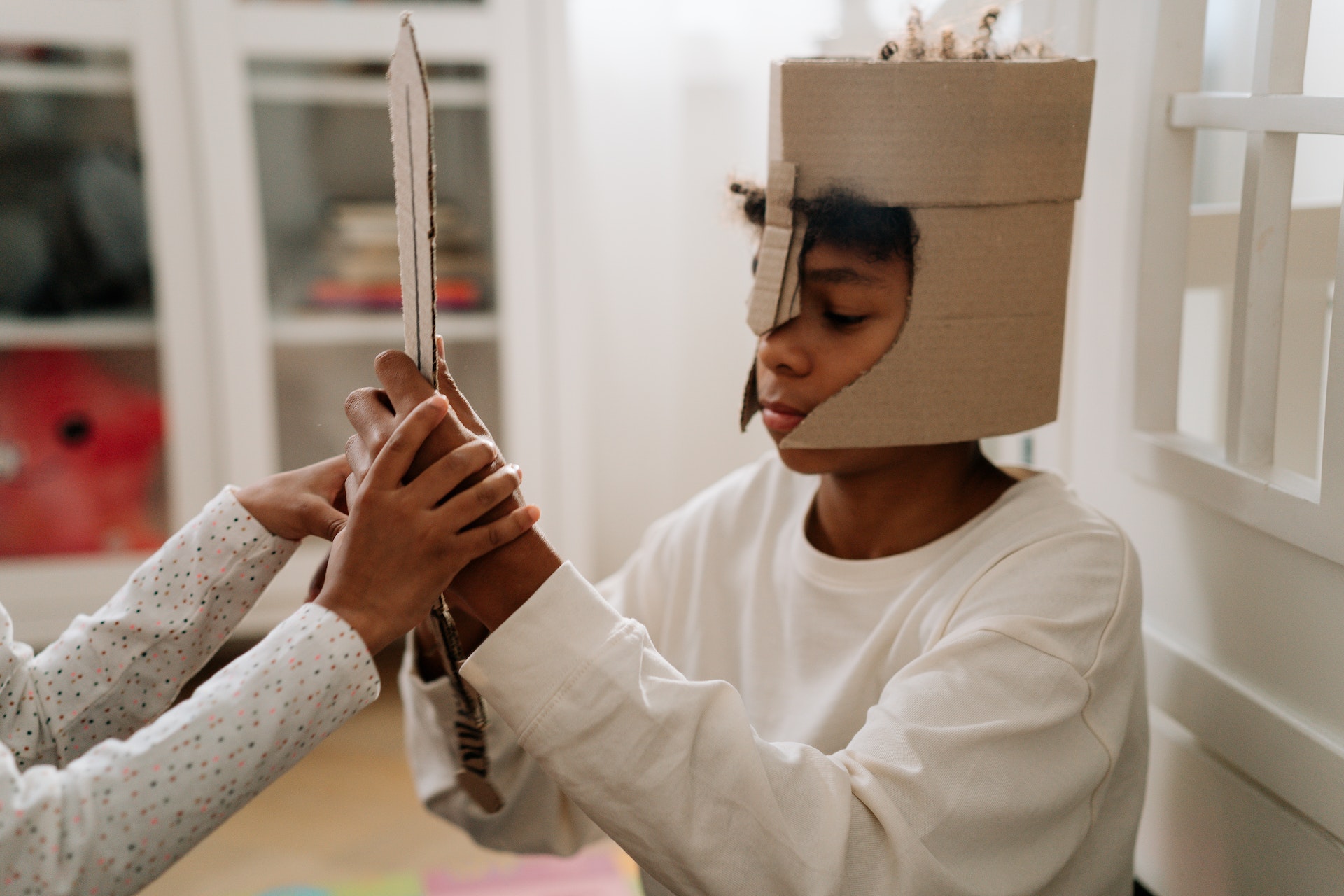 A boy dress up in a costume made from cardboard.