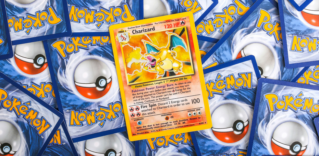 Rare Charizard Pokemon card with other Pokemon cards in the background