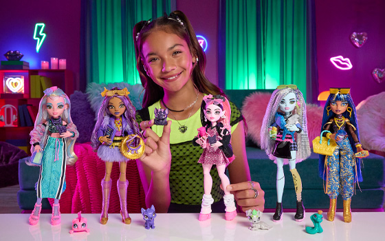 Teenage girl playing with Monster High dolls