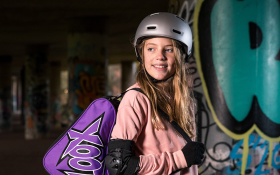 Teenage girl wearing a skateboard helmet