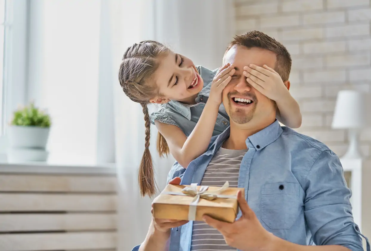 Daughter giving dad a gift.