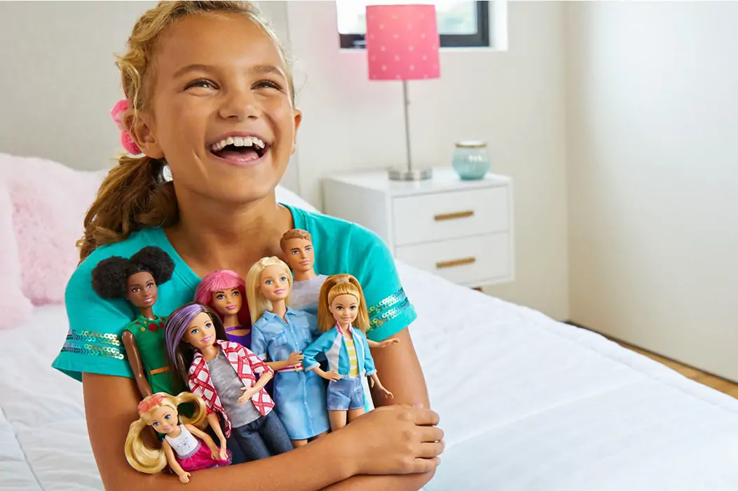 Girl with Barbie dolls