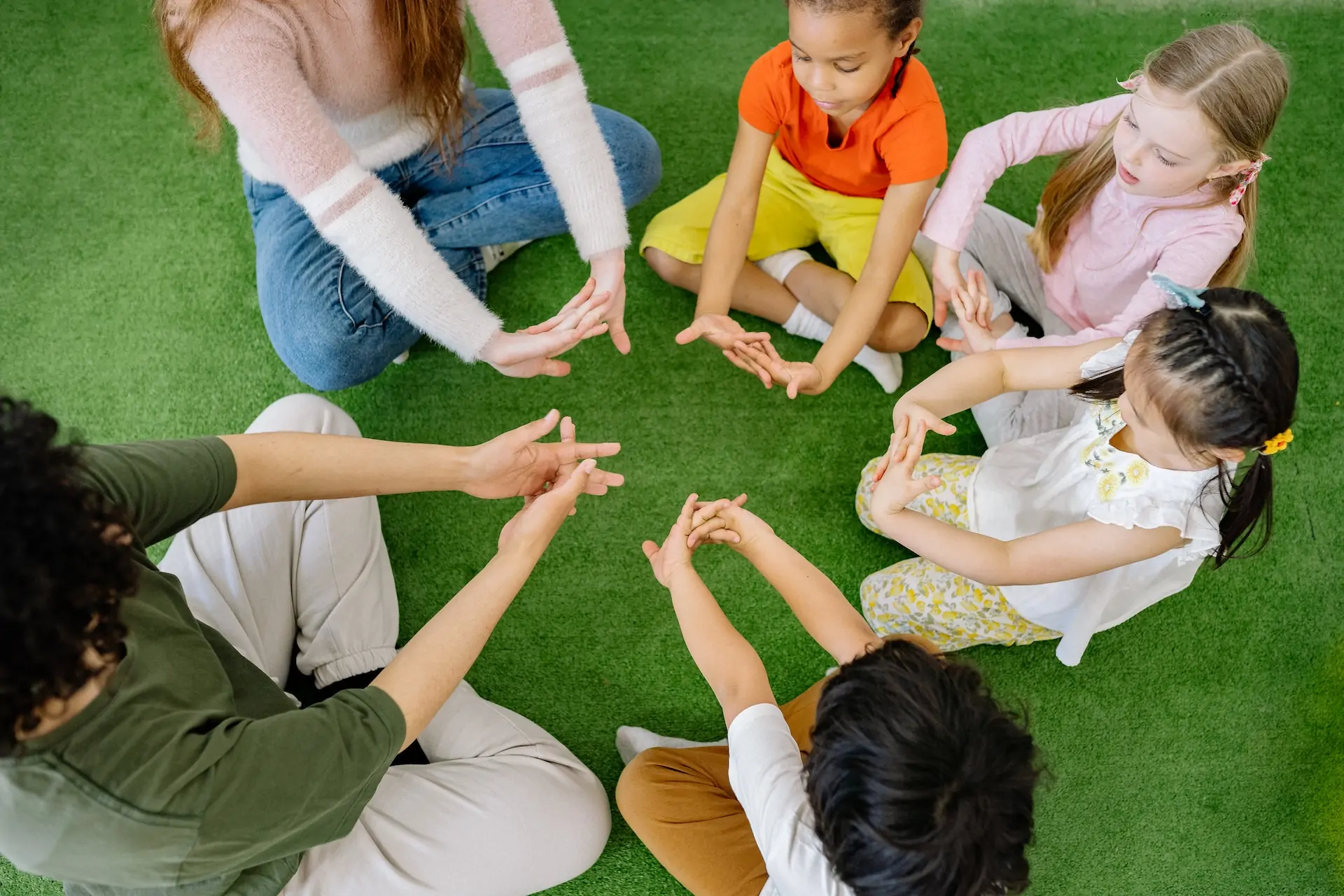 Children in a circle all stretching.