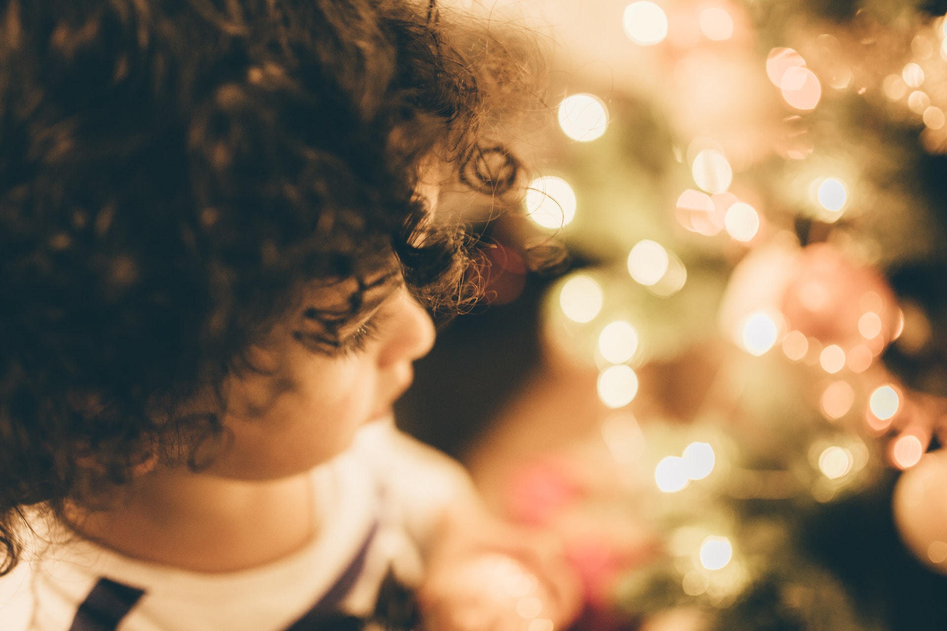 Kid starring at christmas lights.