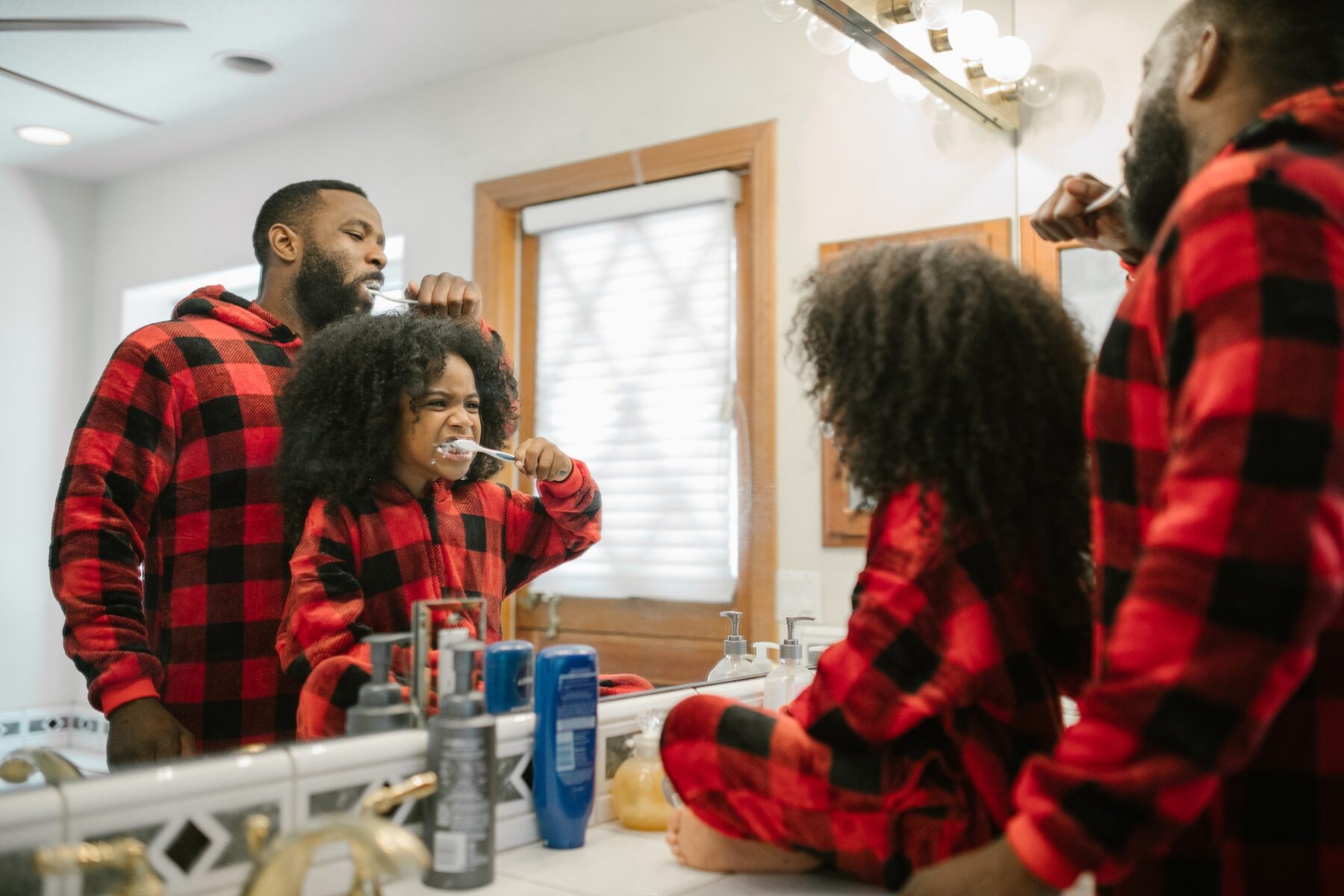 dad and daughter brush teeth