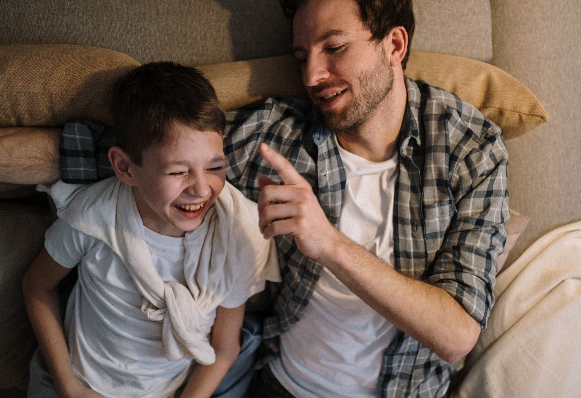Dad laughs with son.