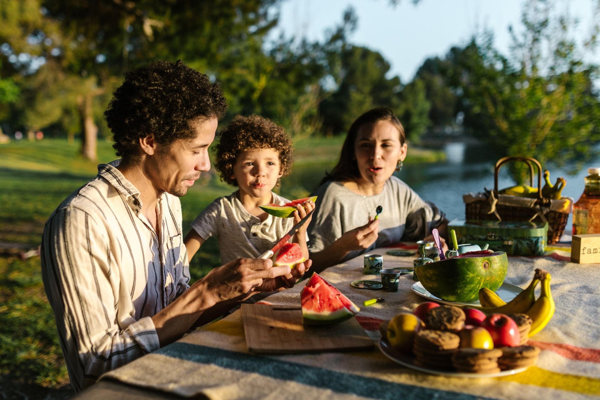 A family eating together outdoors.