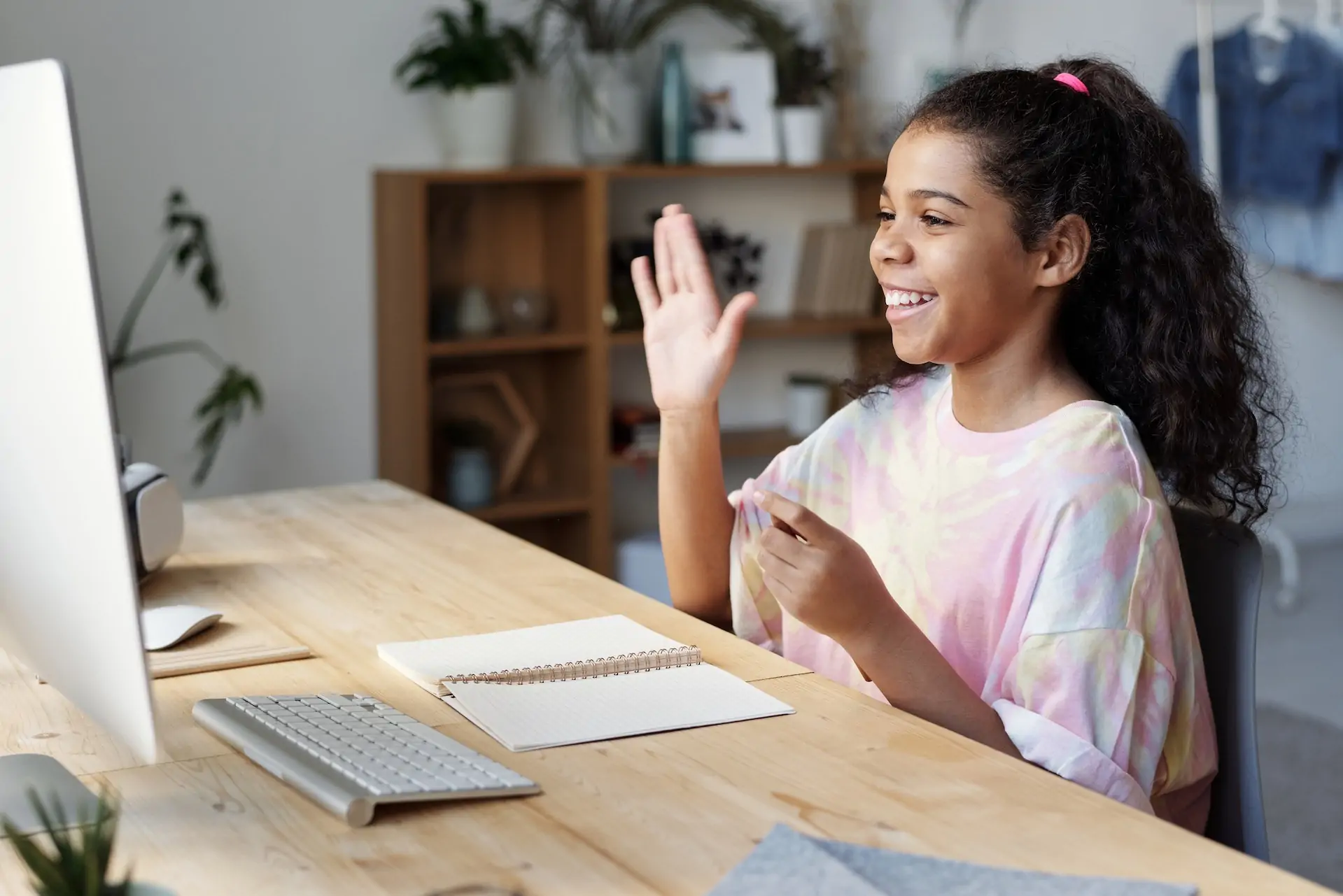 Girl sits on a computer.