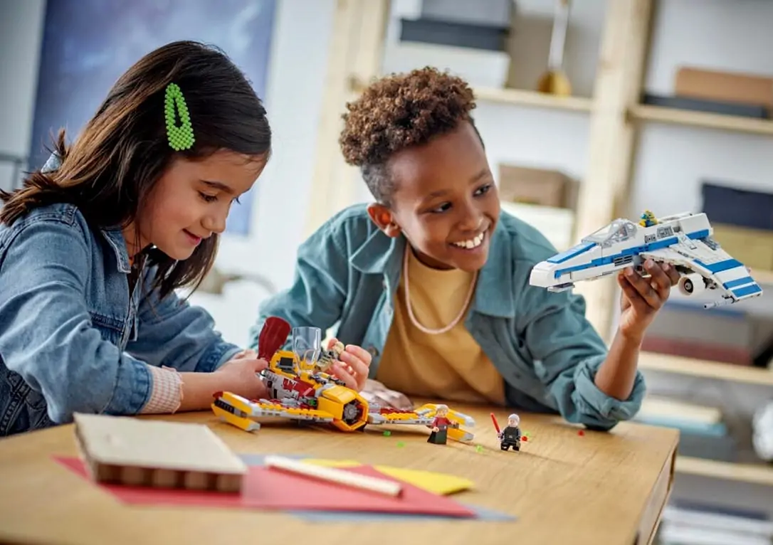 Kids playing together and building lego.