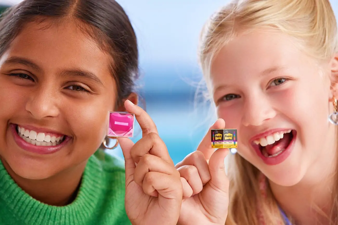Girls smiling and holding mini toys.