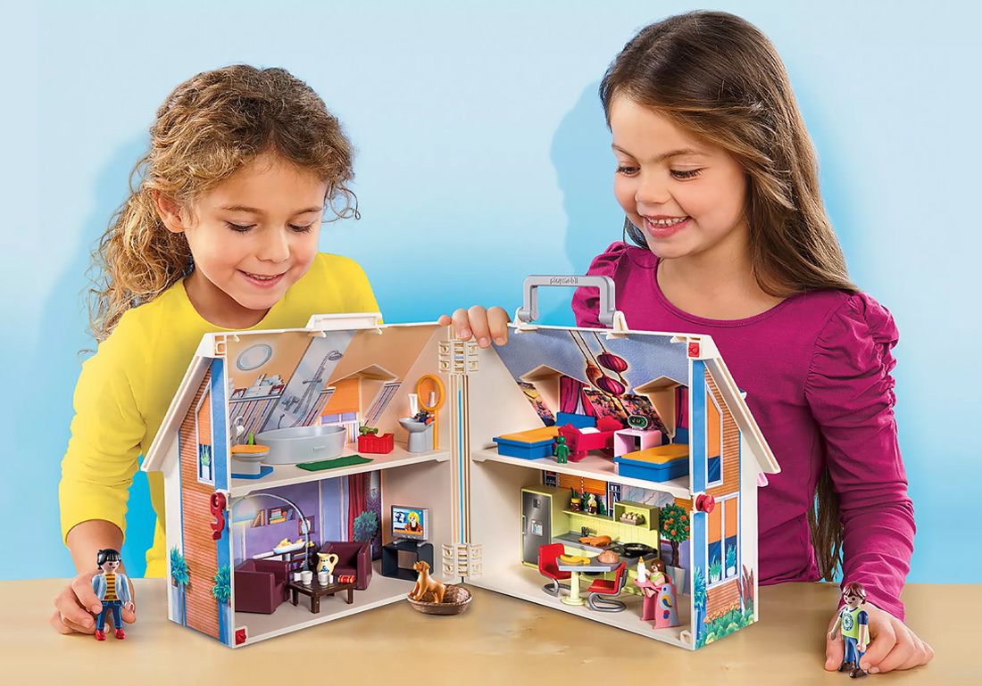 Two girls playing with Playmobil set.