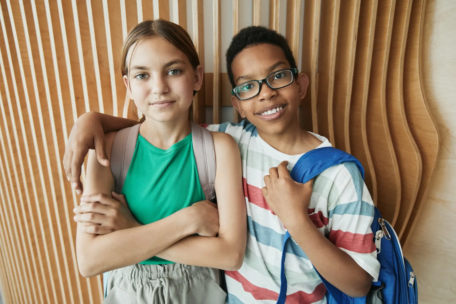 Two kids standing side by side.