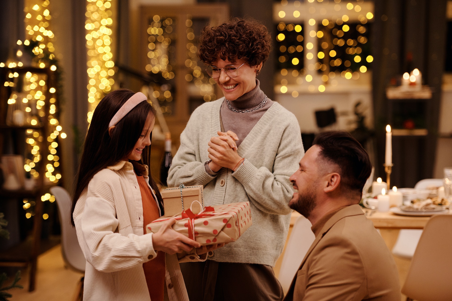 Parents giving child gift.