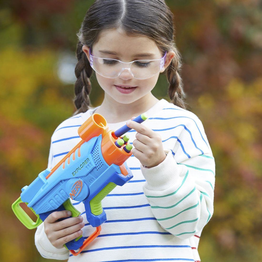 Young girl holds a blaster.